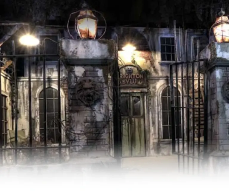 Spooky exterior of Brighton Asylum with gothic architecture and dim lighting for a haunted attraction atmosphere in Passaic County, NJ.